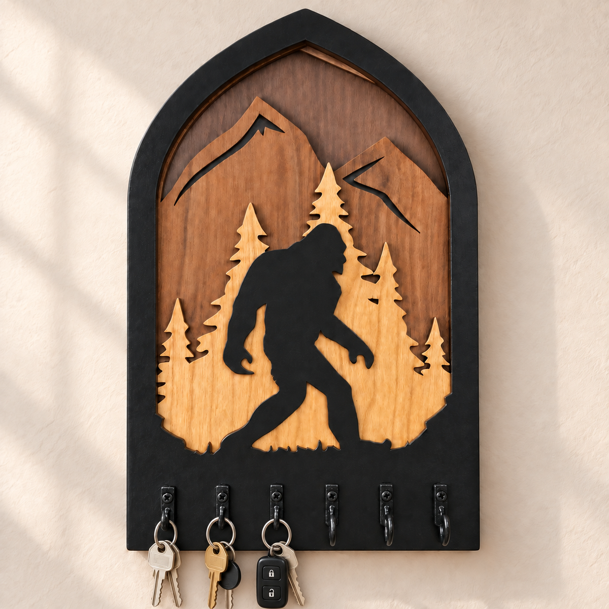 Bigfoot wooden key rack shown holding several sets of keys