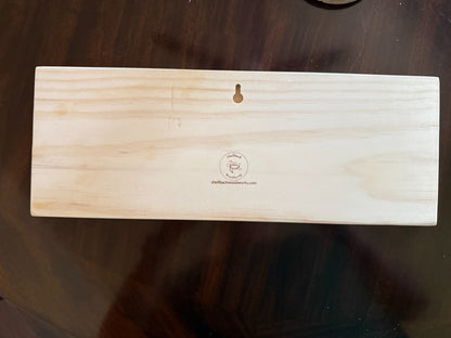 Back of a Shellback Woodworks pine wall board with routed keyhole hanger and maker logo