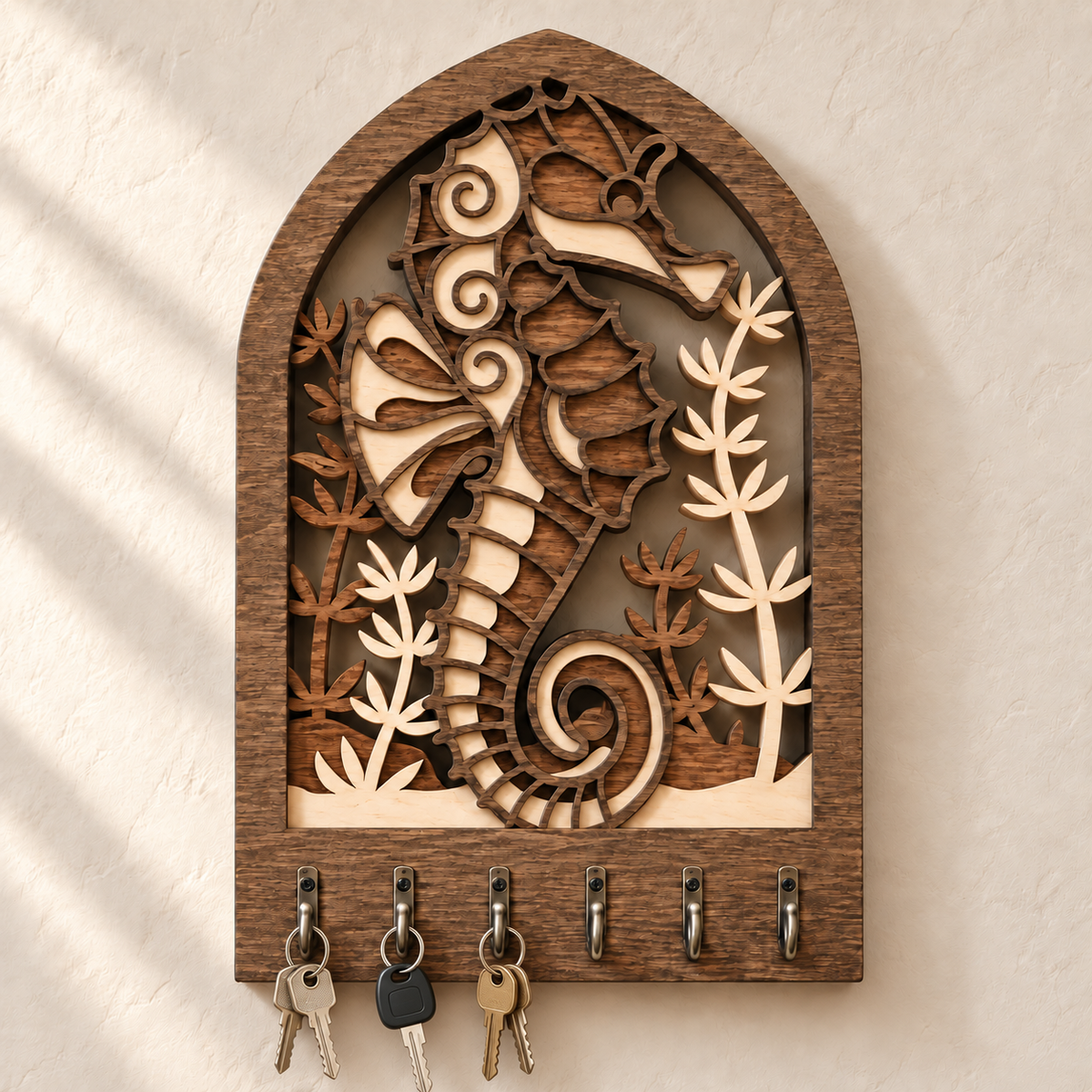 Seahorse wooden key rack shown holding several sets of keys