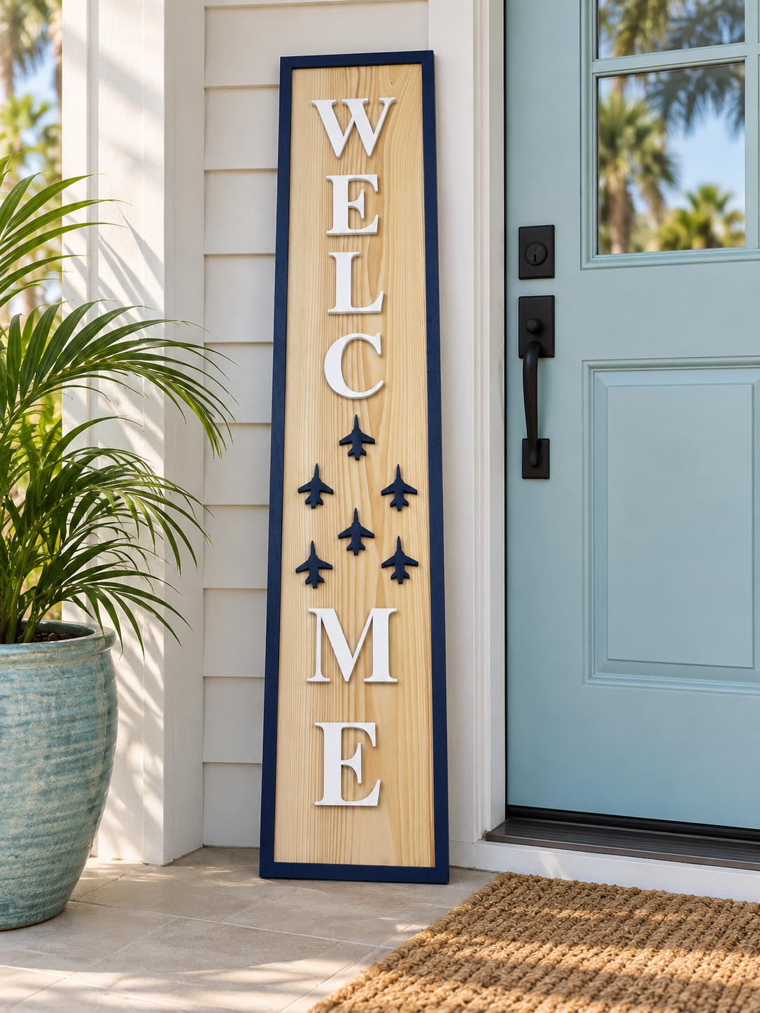 Four-foot handcrafted six-jet WELCOME porch leaner styled beside a coastal front door