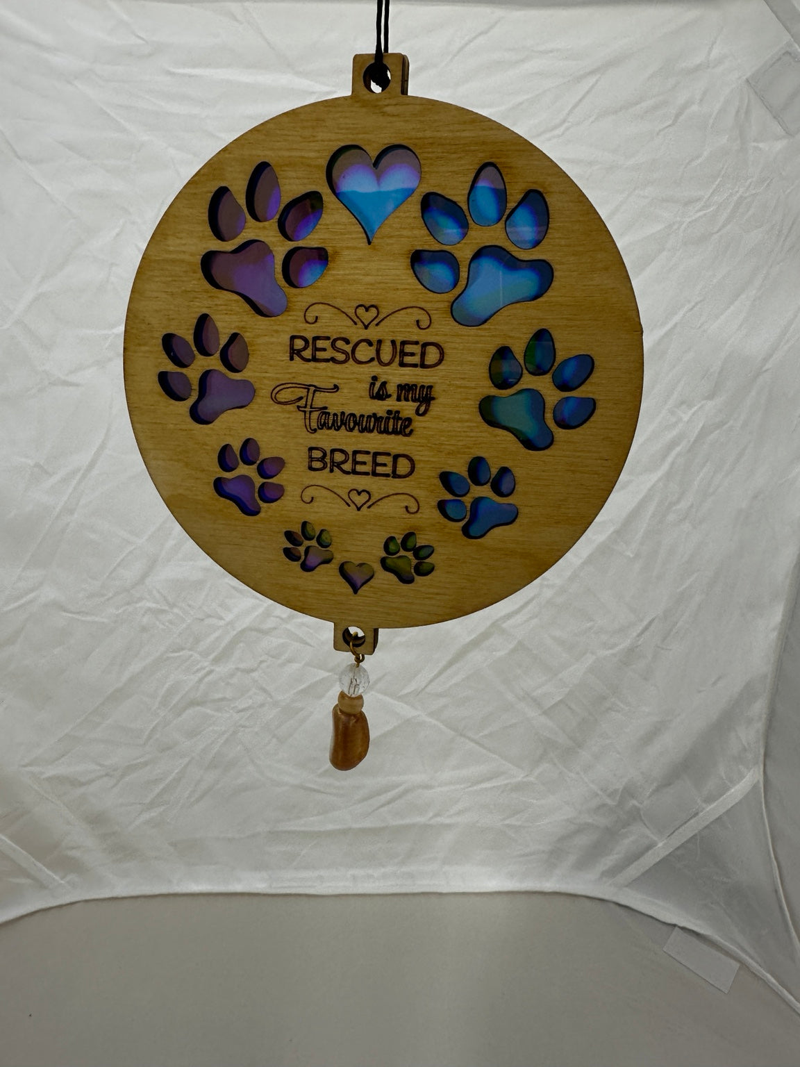 Finished iridescent wooden suncatcher with decorative bead drop